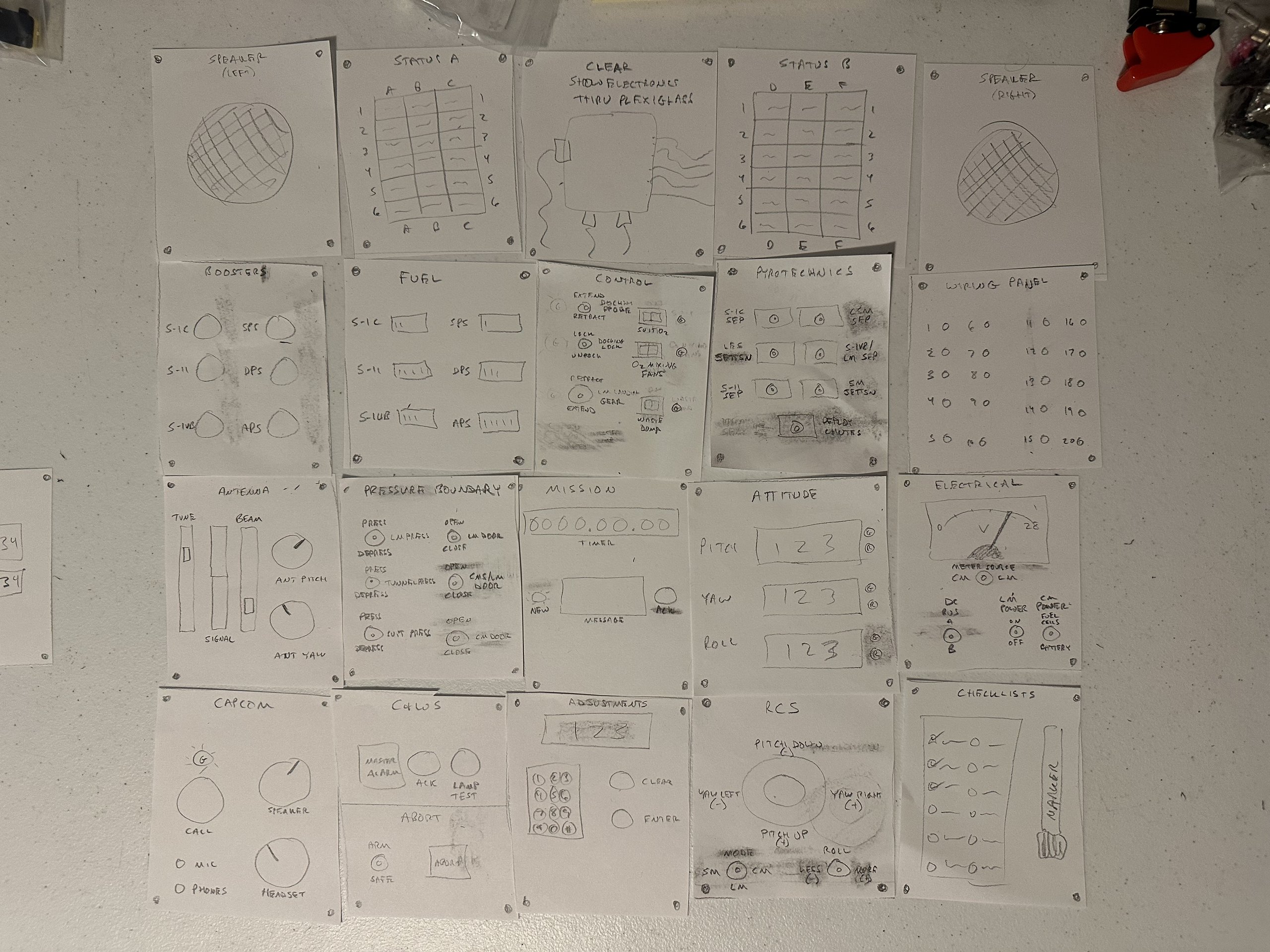 Pencil sketches of the Apollo simulator panels laid out on a table in a 4 by 5 grid