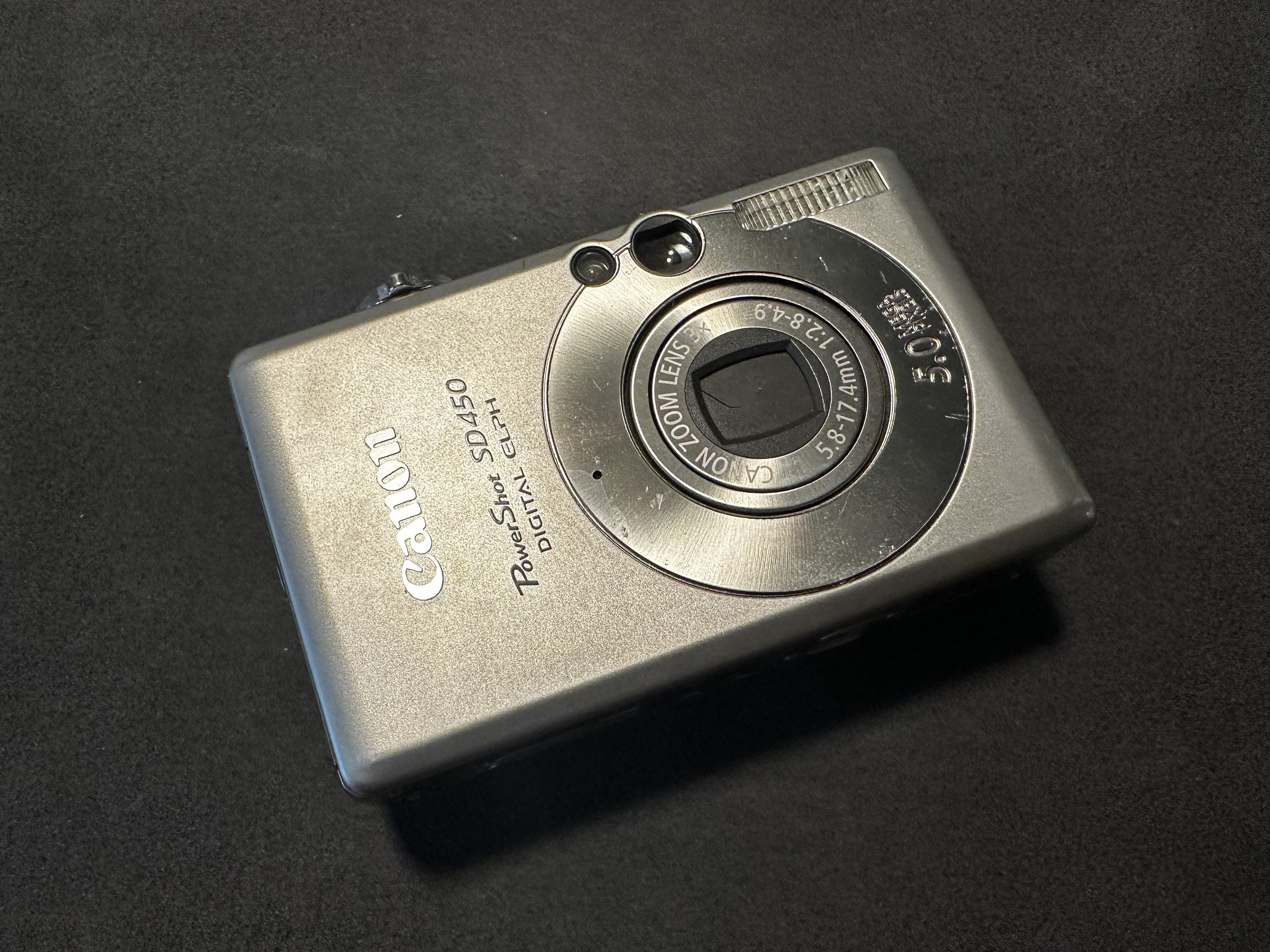 Canon PowerShot SD450 digital camera on a dark background