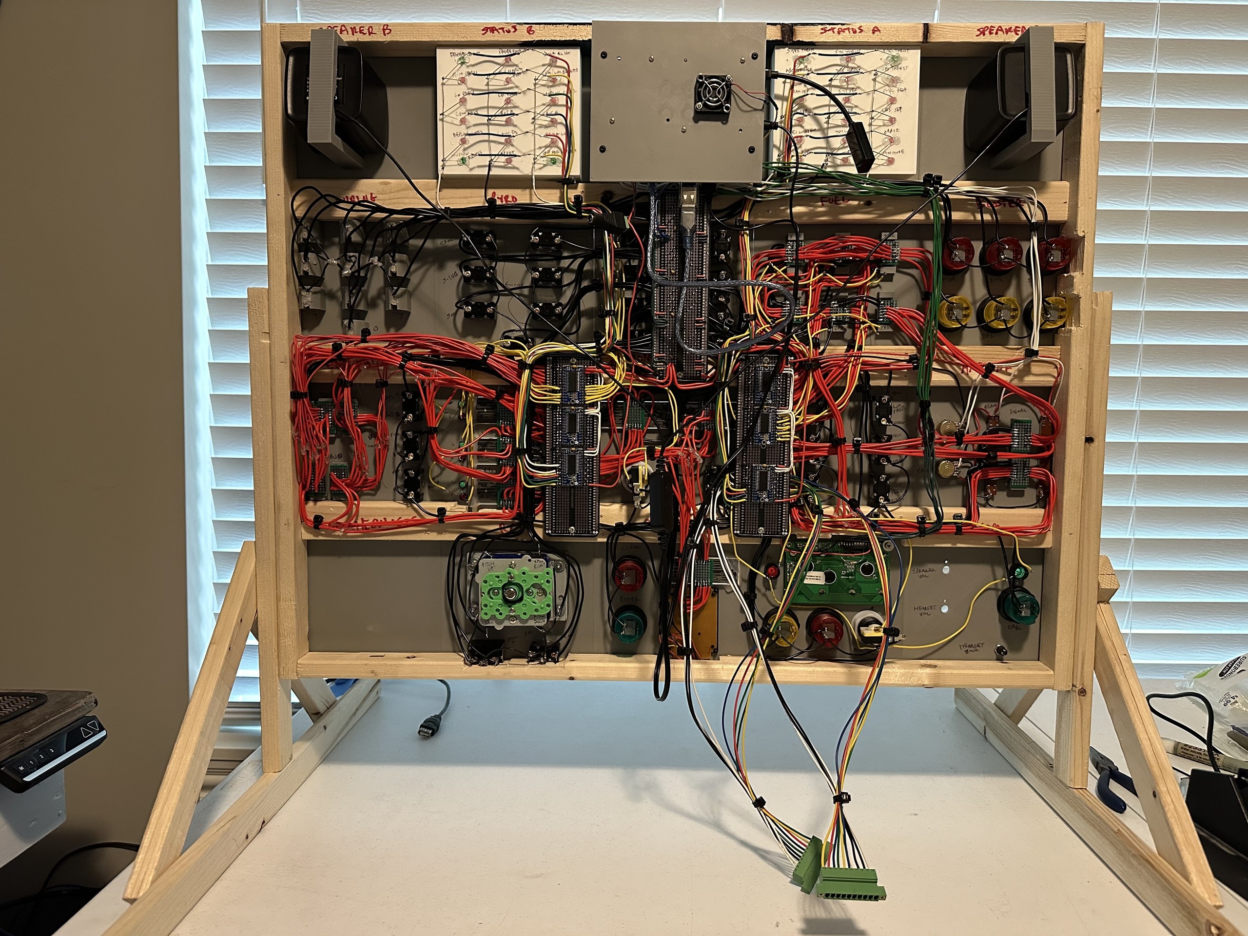 Fully wired back of the Apollo simulator panel with green Mission Map connectors hanging below